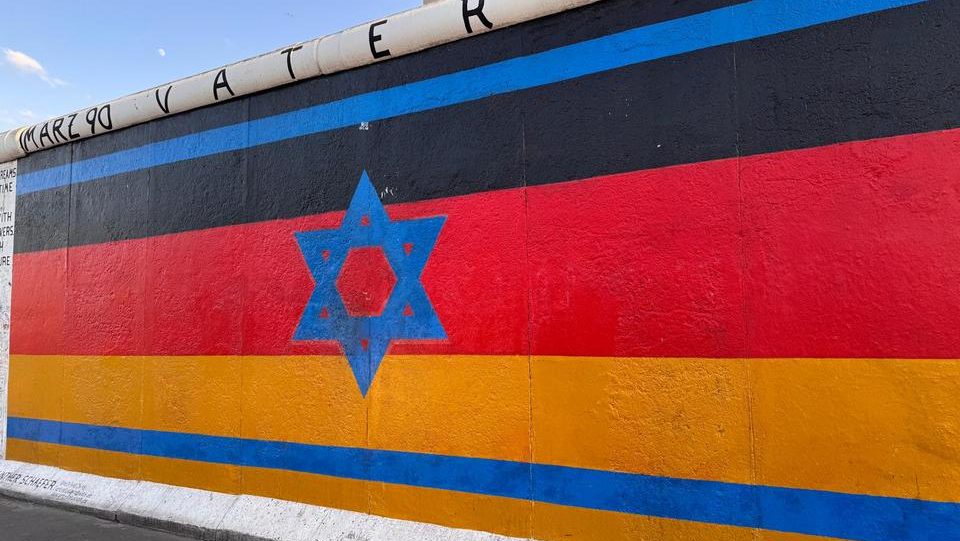 East side gallery in Berlin - Magen david over Germany flag art